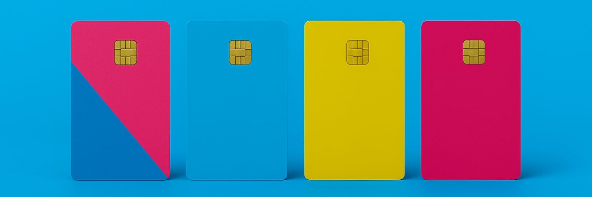 Four credit cards standing upright with pink, yellow, and blue designs on a bright blue background.
