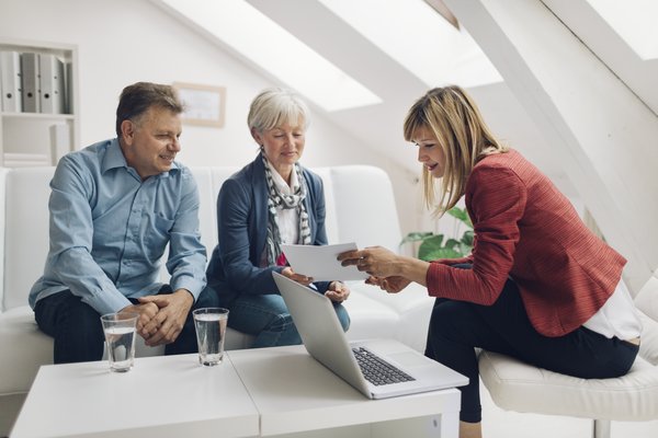 A couple works with their financial advisor.